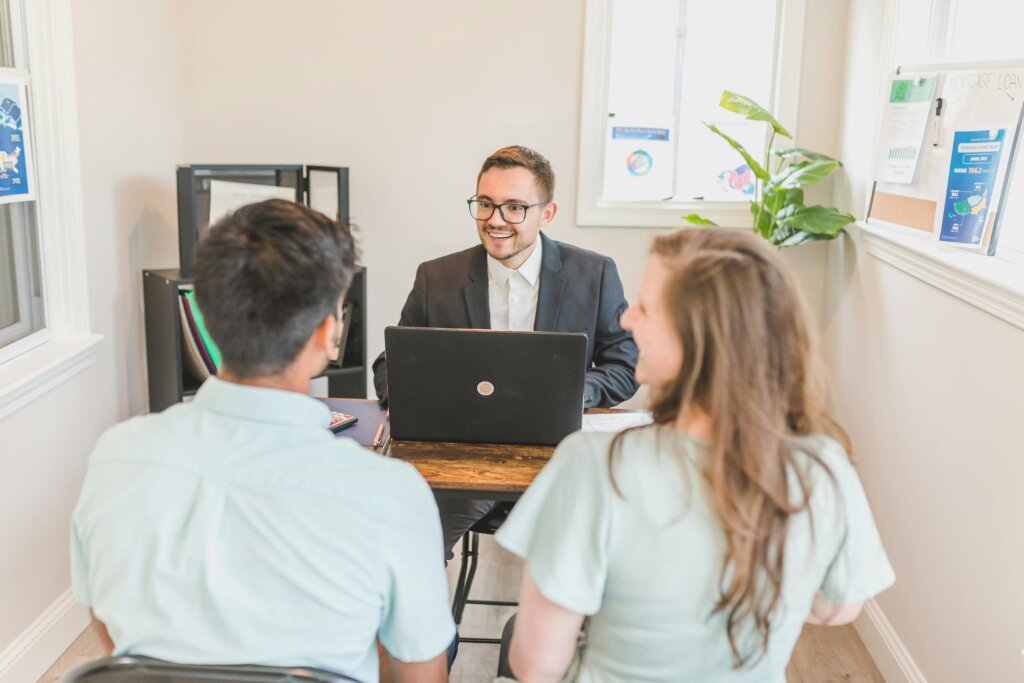 couple discussing with a real estate agent