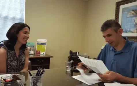 Elana's photo with a client at the closing table