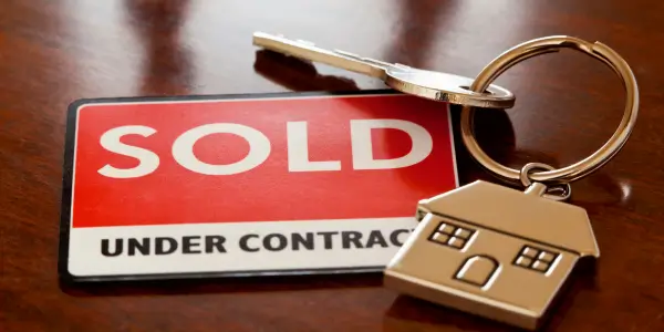Keychain with "Under Contract" and "Sold" tags, symbolizing success in how to sell a house in probate.