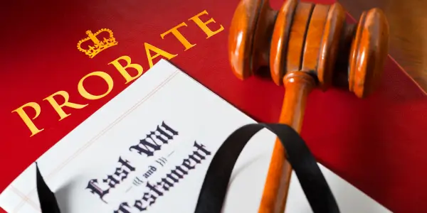 a book about probate under a last will and testament and a gavel to help discover what happens to a house during probate