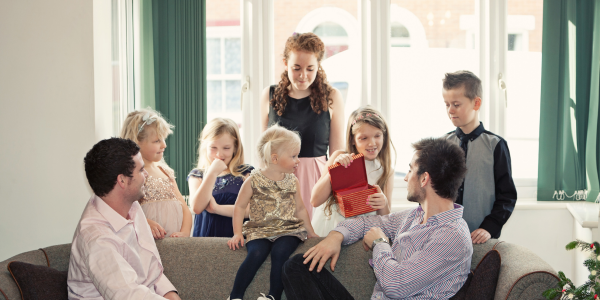 A family on a couch while they discuss do all heirs have to agree to sell property