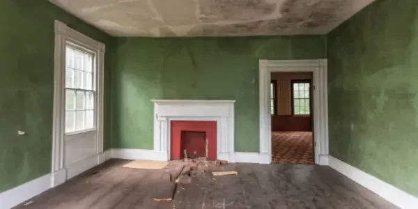 an empty living room of a house in bad shape