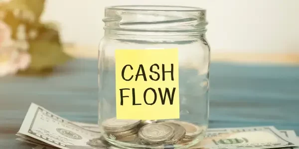 a jar with few coins with a label "cash flow"