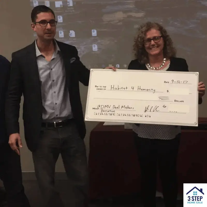 Josh presenting a donation to Habitat for Humanity at a Chamber of Commerce event