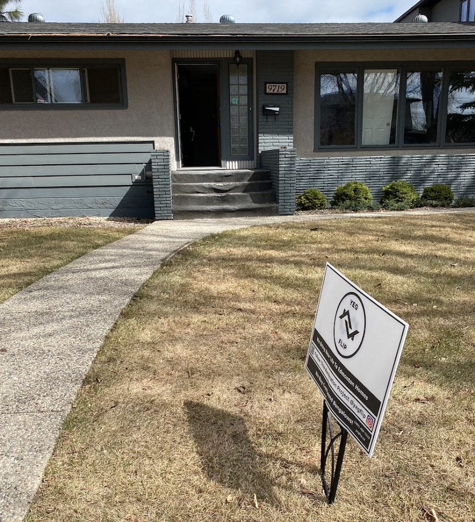 House bought by yeg home buyers with our we buy houses sign in the front lawn