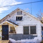 Abandoned Home In Disrepair With Barred Windows