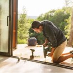 screen door repair man fixing a door frame