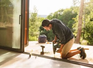 screen door repair man fixing a door frame