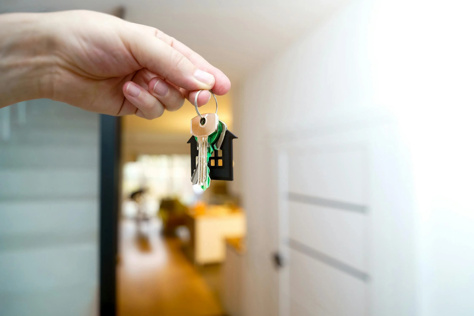 A hand holding keys to a house