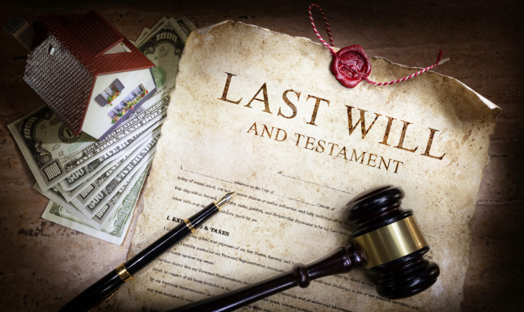 Learn the right way to sell your inherited Illinois home Last will and testament on desk of Chicago resident with pen, gavel, model house, and cash