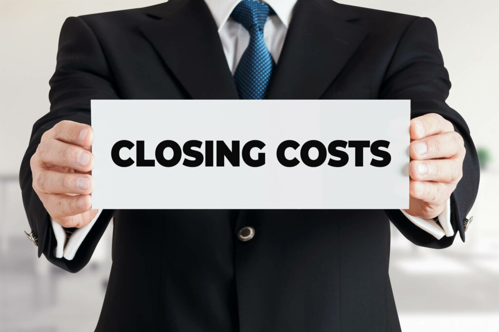 Learn how to choose the right cash buyer for your Illinois home. Bloomington, IL home buyer holds sign reading "Closing Costs"