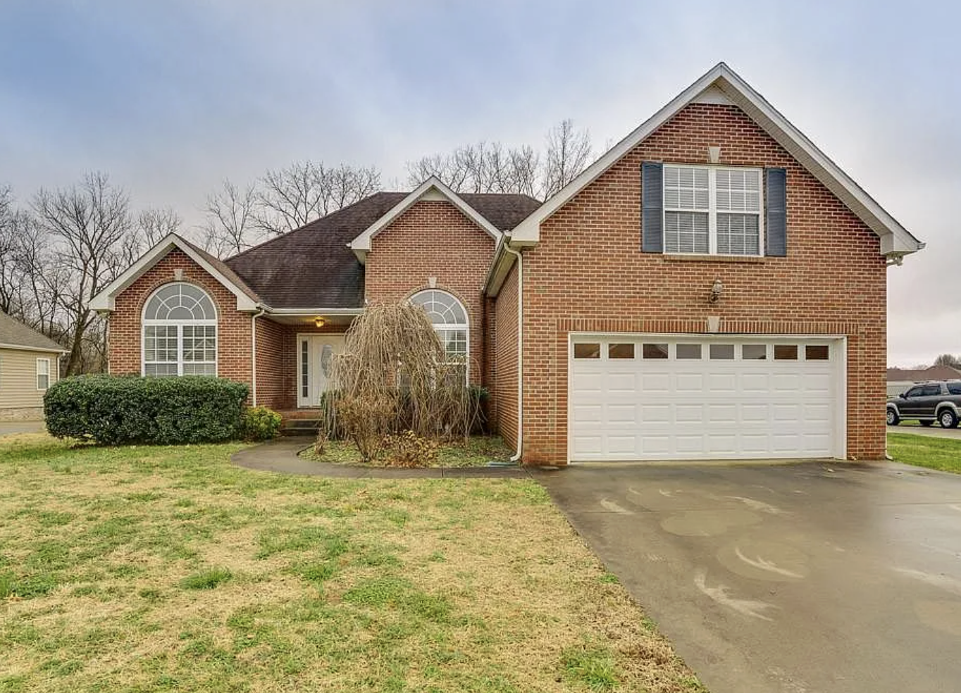 Two-story brick Clarksville home — a typical property we buy and close on remotely