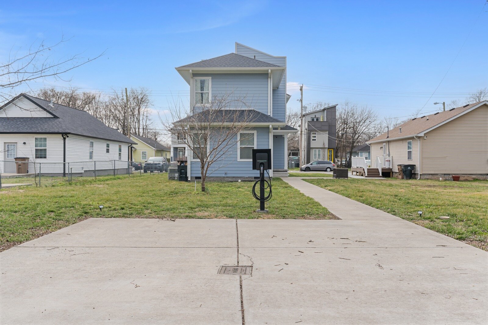 Two-story Nashville house with a wide concrete driveway, bought for cash and sold as-is