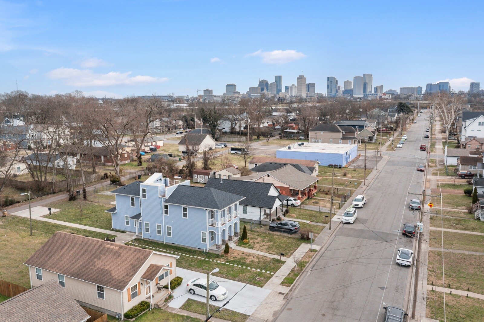 Nashville skyline behind a North Nashville street of new-build infill homes next to older houses