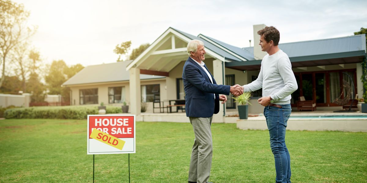 senior shaking hands with revitalize property solution company manager