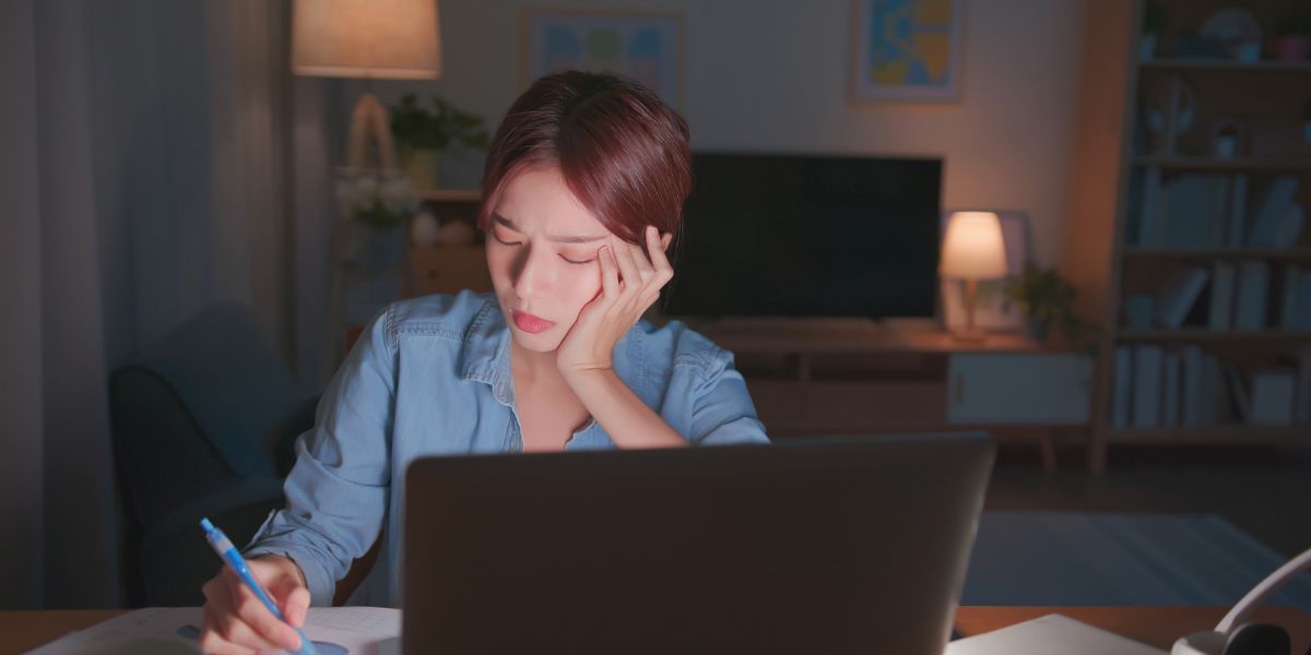 Woman working on laptop worried about foreclosures