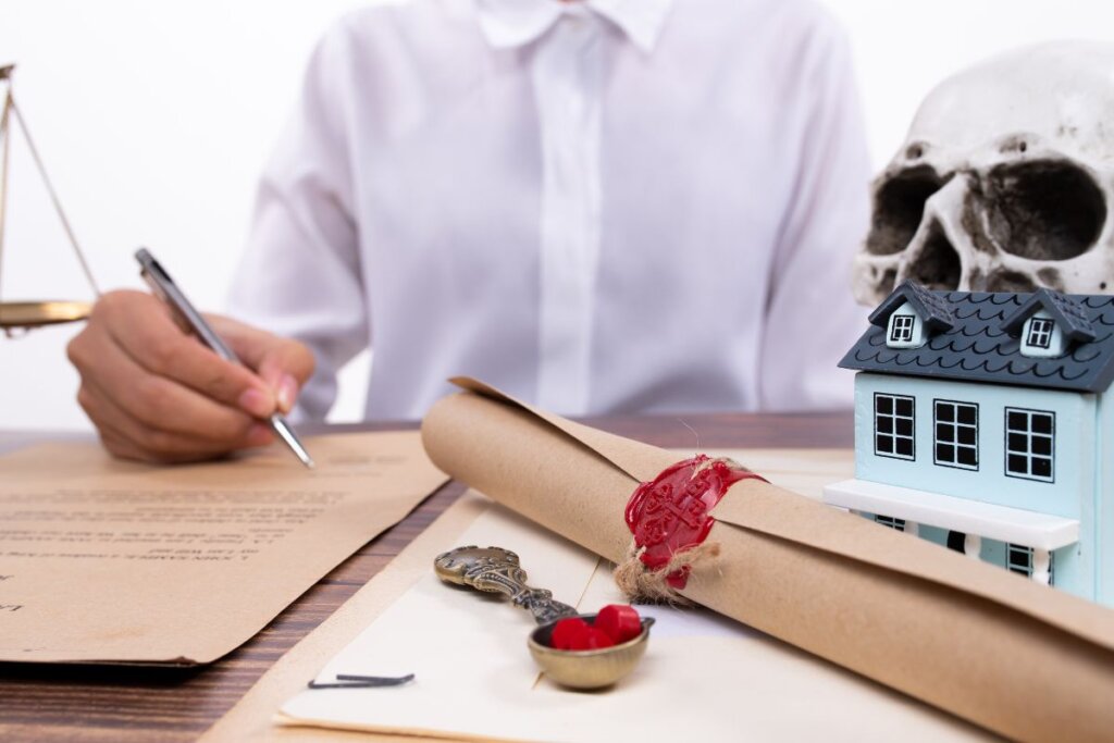 Signing legal documents for an inherited house, symbolizing the process of managing inherited property with assistance from REvitalize Property Solutions for a seamless sale.