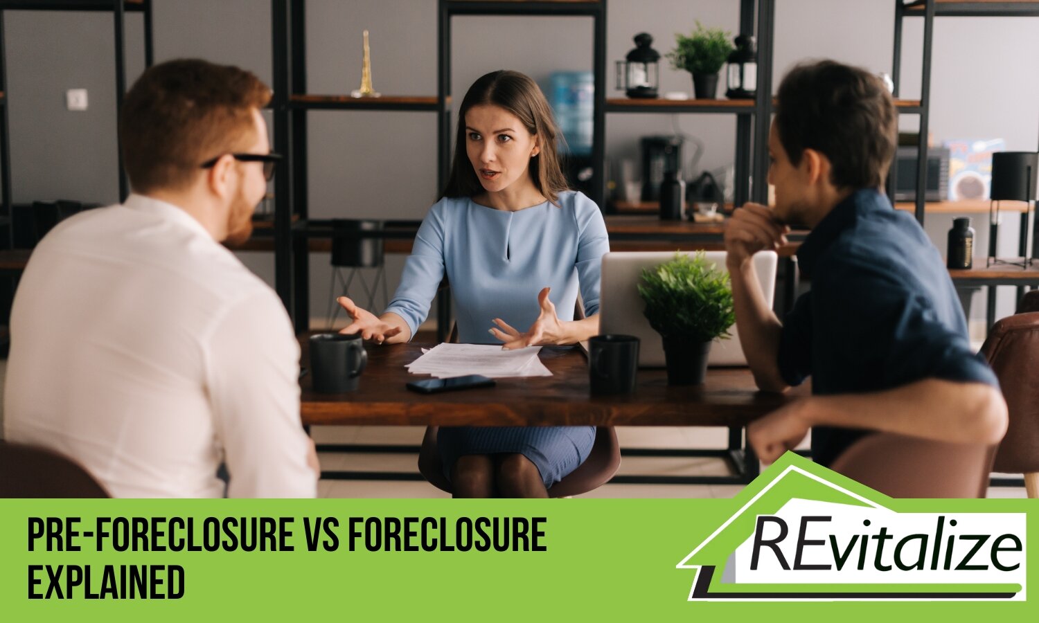 A professional explaining the differences between pre-foreclosure and foreclosure to two homeowners, with the REvitalize Property Solutions logo.