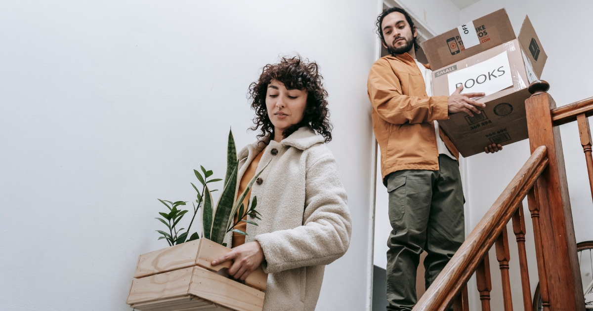 Young couple packing and moving from their Mid-City home while preparing for a job relocation.