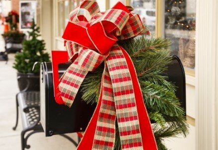 black mailbox with red Christmas ribbon