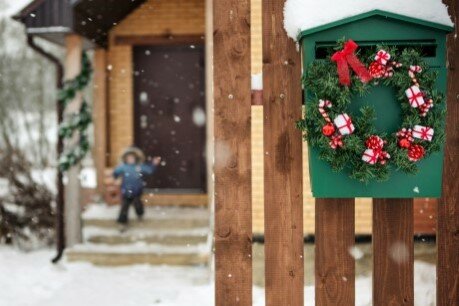 Flat mailbox with small Christmas wreath attached to the front
