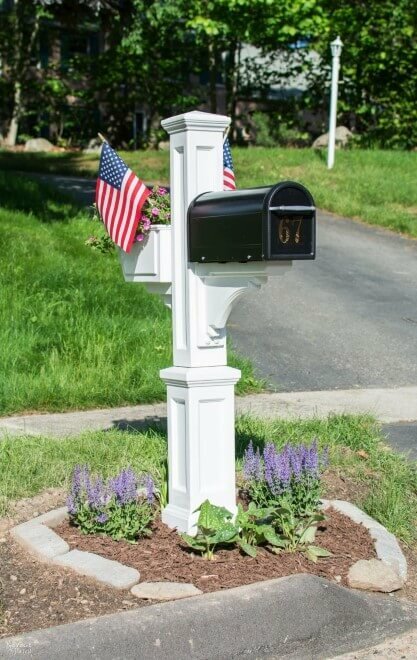 White mailbox post with lavender planted around the mailbox