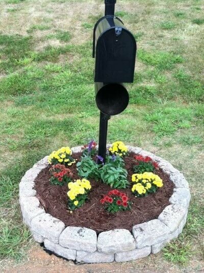 Black mailbox with raised flower bed