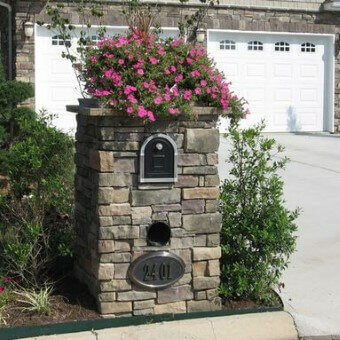 Brick mailbox with pink flowers on top