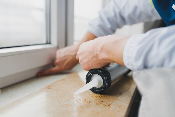 smoothing caulk with finger