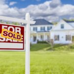Sold real estate “For Sale” sign changed to “Sold” in front of a home in Sacramento