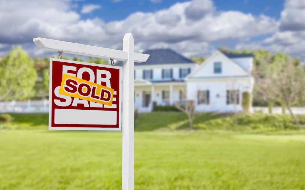 Sold real estate “For Sale” sign changed to “Sold” in front of a home in Sacramento