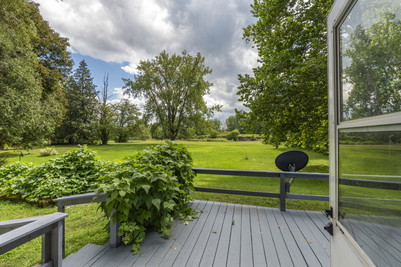 Back deck overlooking Fish Creek at affordable waterfront property near Sylvan Beach NY