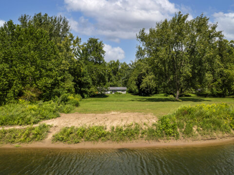 Scenic backyard with river access at affordable waterfront home for sale in Blossvale NY