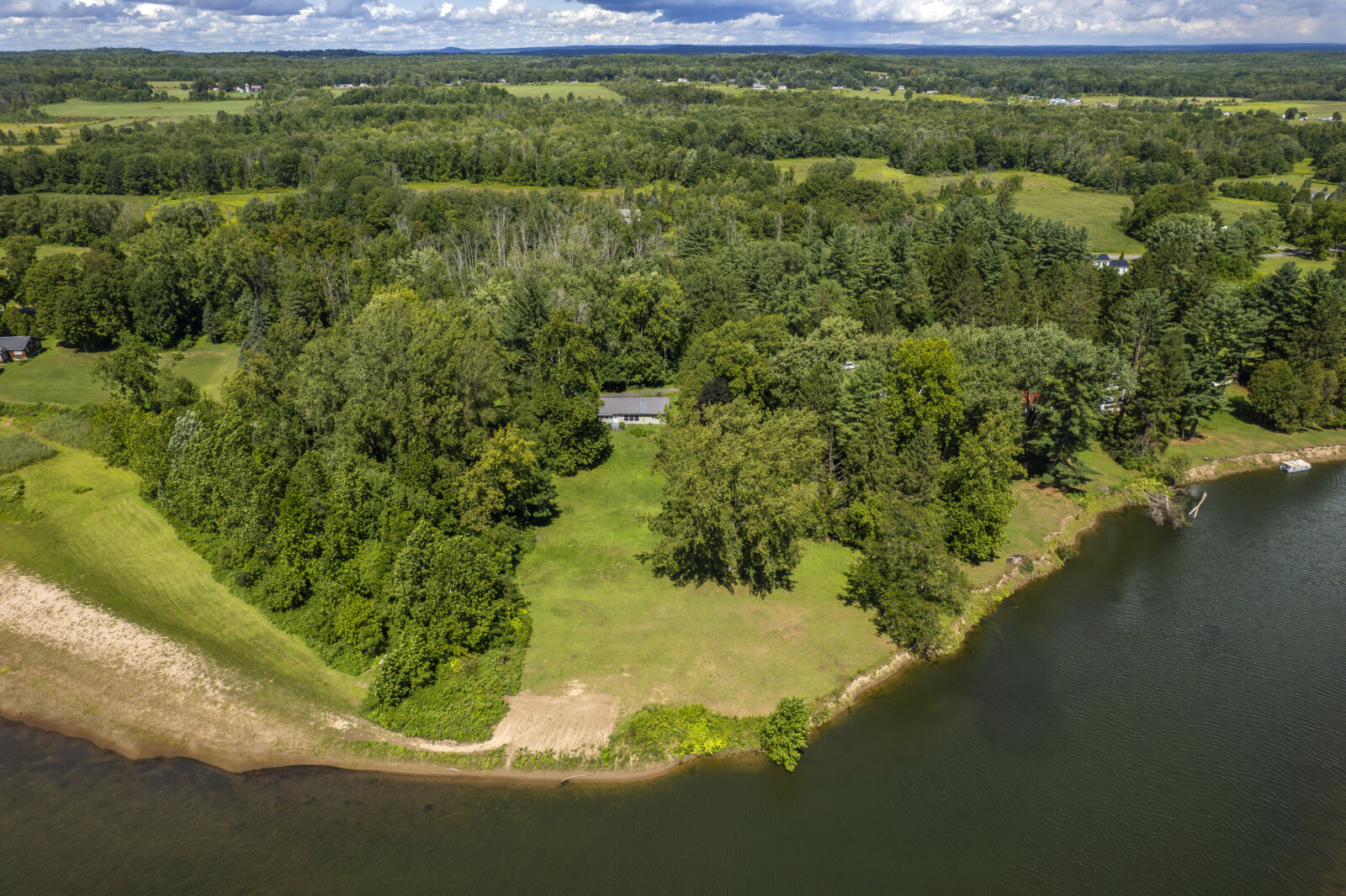 Aerial shot of Fish Creek waterfront property near Sylvan Beach NY surrounded by greenery
