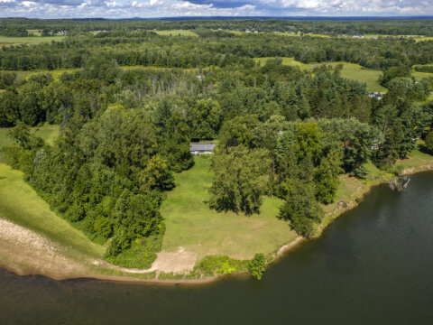 Aerial shot of Fish Creek waterfront property near Sylvan Beach NY surrounded by greenery