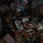 A room packed with items in a hoarded home Tri-Cities Homebuyers bought and repaired.