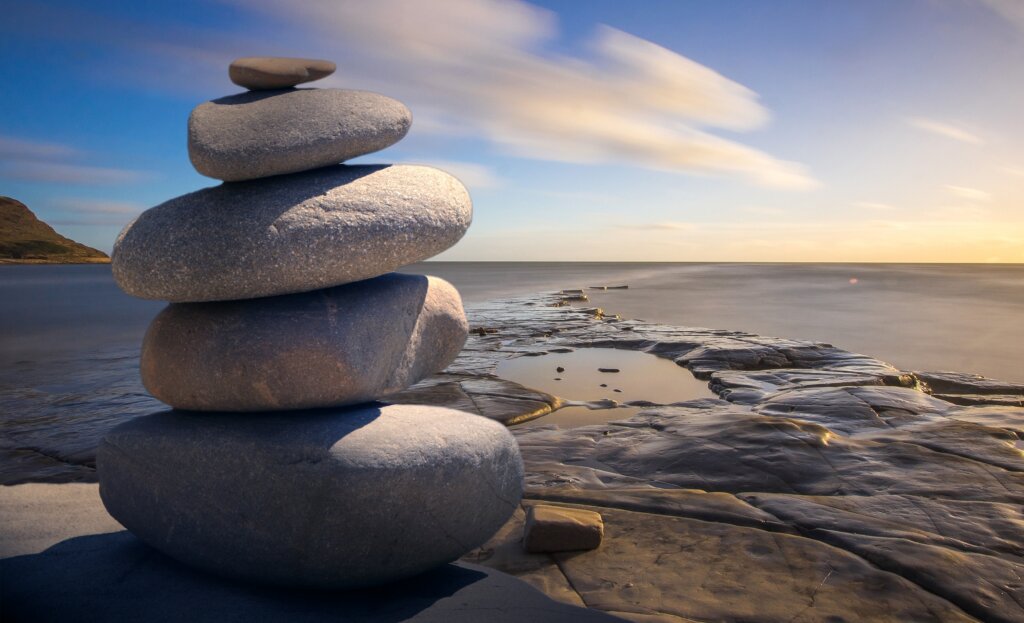 Rocks perfectly stacked on top of one another in a peaceful environment.