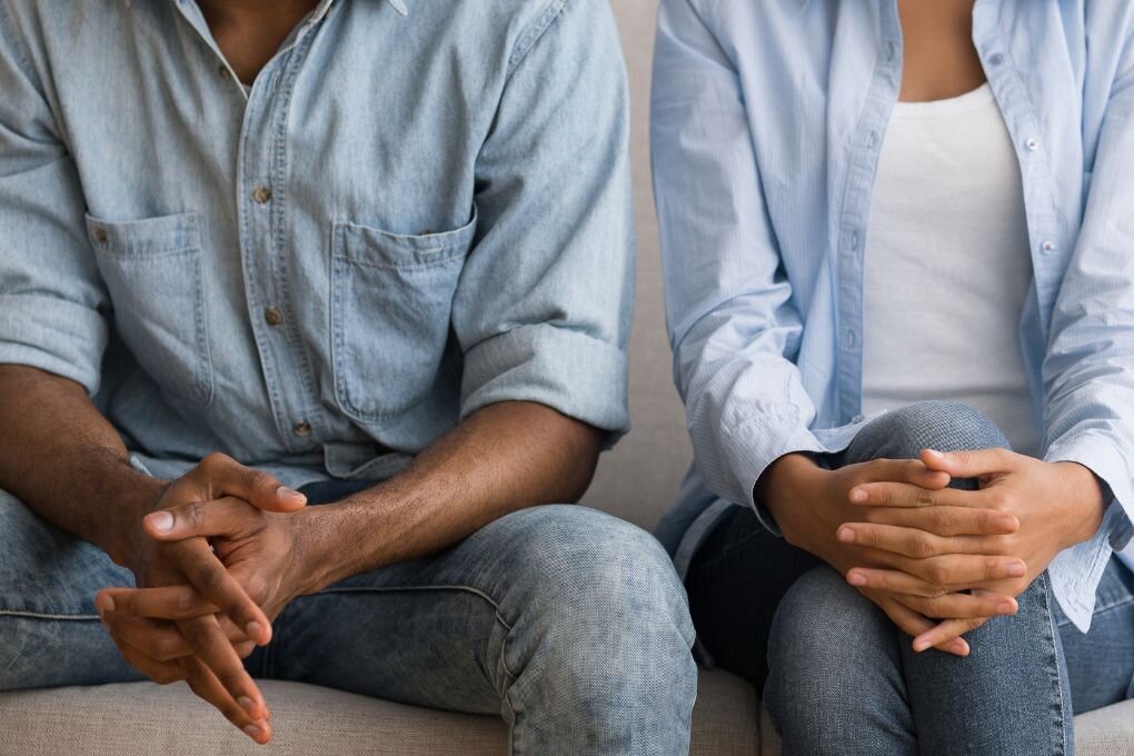 Unrecognizable Afro Couple Sitting on Couch at Marital Counselor.