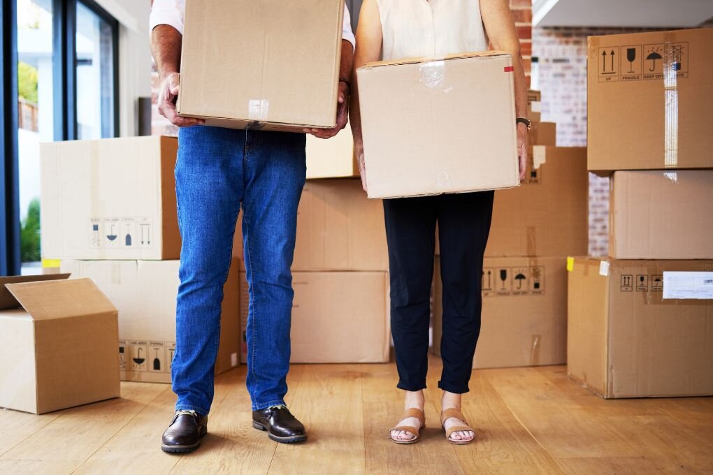 Boxes Full of Possessions, Hearts Full of Priceless Memories. Shot of an Unrecognizable Mature Couple Carrying Boxes on Moving Day.