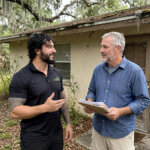 A Jacksonville homeowner talking with Jesse Wyatt of Synergy Buys Houses in front of a Florida home with a county sale notice posted by the door