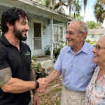 Jesse Wyatt shaking hands with happy sellers in front of their Florida home after a cash closing