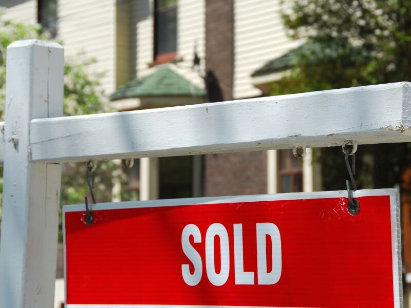 red house sold sign