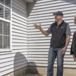 Rapid Fire Home Buyers meeting with a homeowner reviewing their home in order to buy their house quickly.