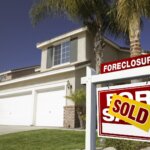 Foreclosure house with a sold sign in the yard after a homeowner sold their house quickly with Rapid Fire Home Buyers.
