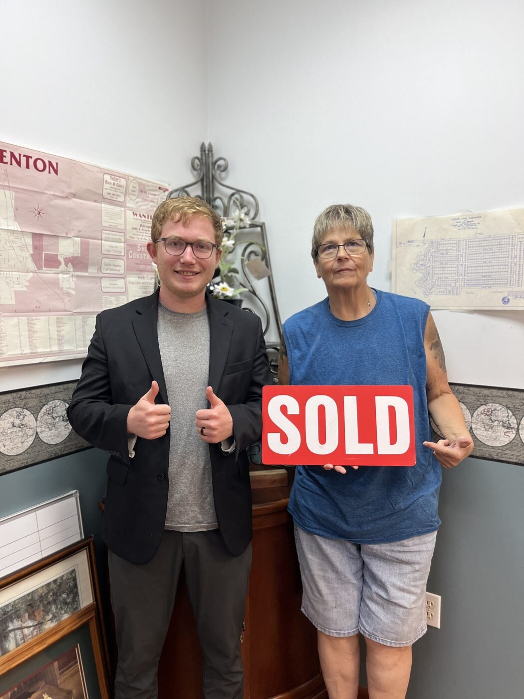 A closing-day celebration with a red SOLD sign.