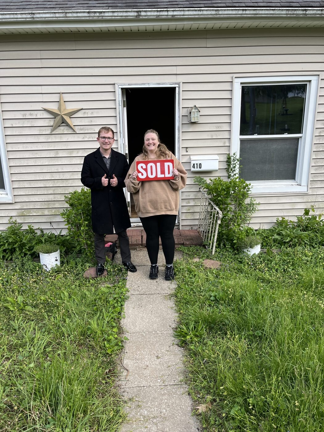 A home-sale celebration on the front walkway.