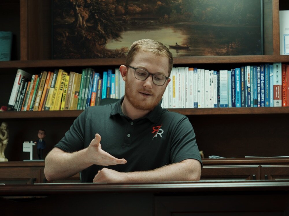 Cole Rorebeck seated at his desk for an in-person seller consultation