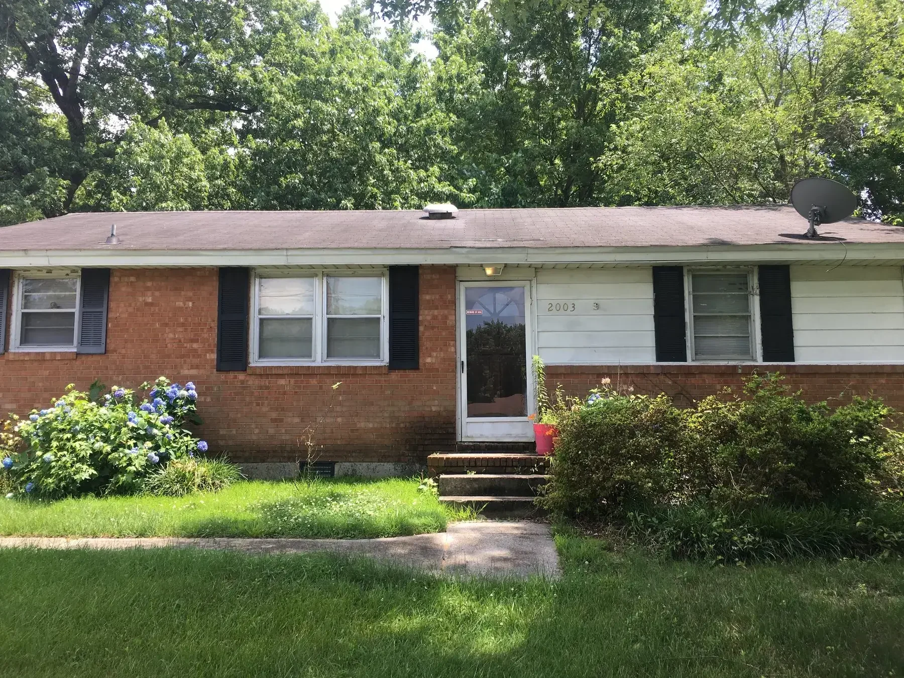 Brick home with visible wear and aging exterior, representing a property that can be sold quickly for cash in the Piedmont Triad area.