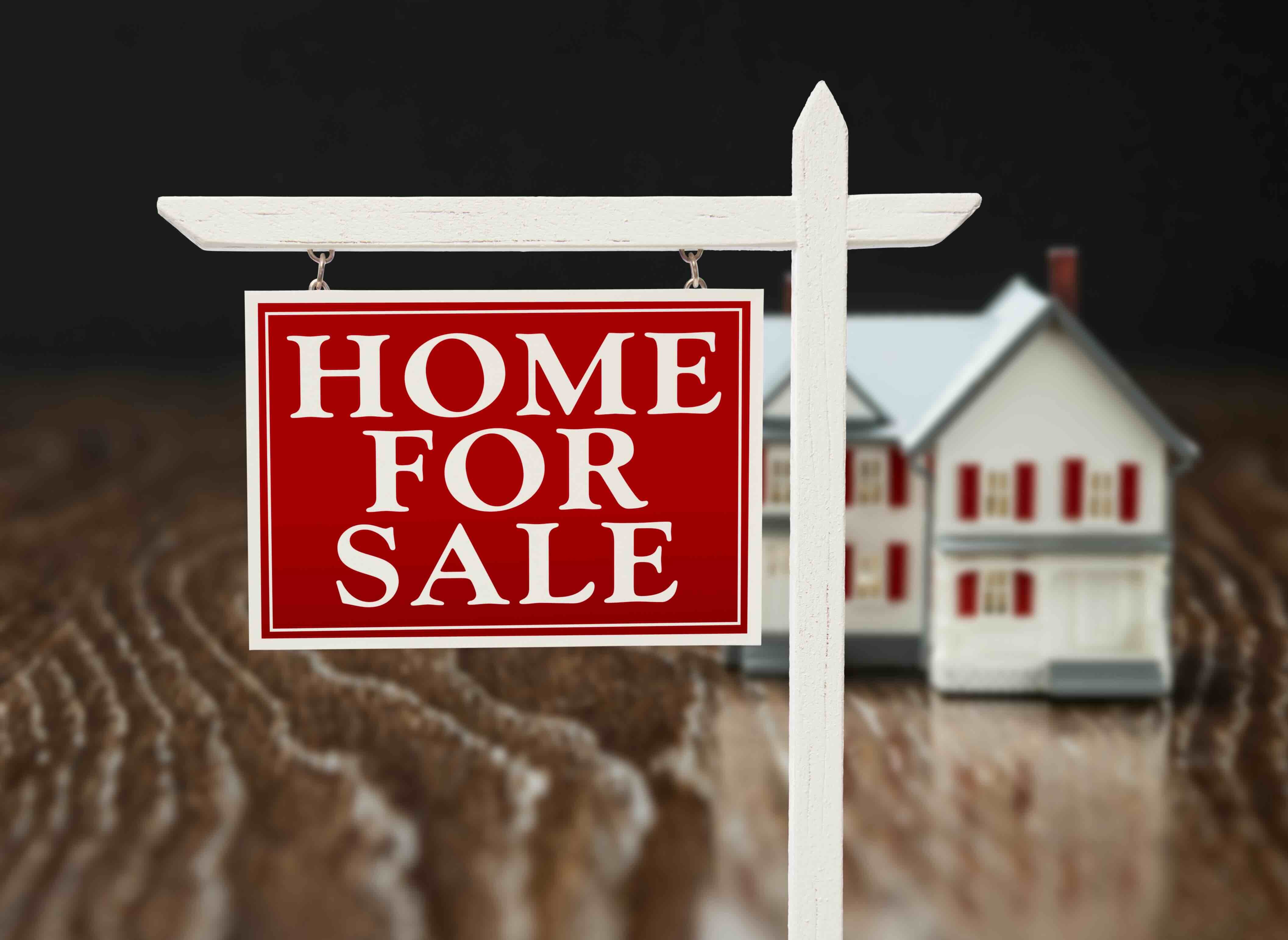 Photo of a for sale sign outside of a house – an illustration for the Lehti Homes Guide to selling your home in Greensboro.