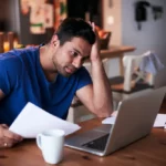 Man having a problem in front of laptop